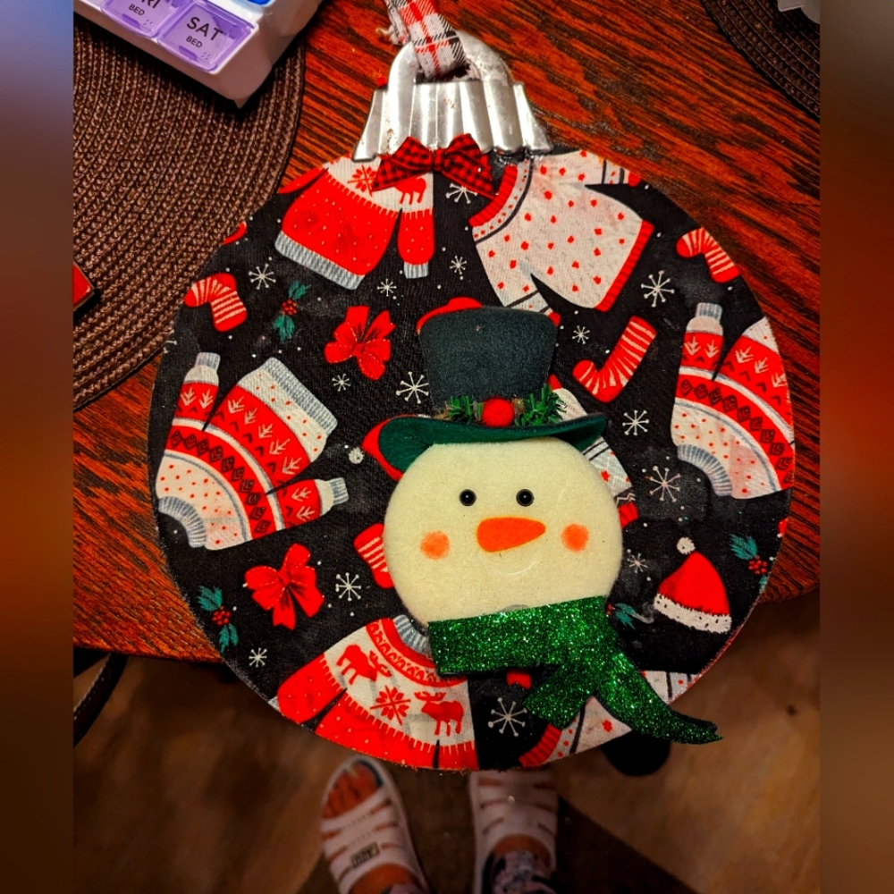 Large bell ornament with frosty the snowman attach.
